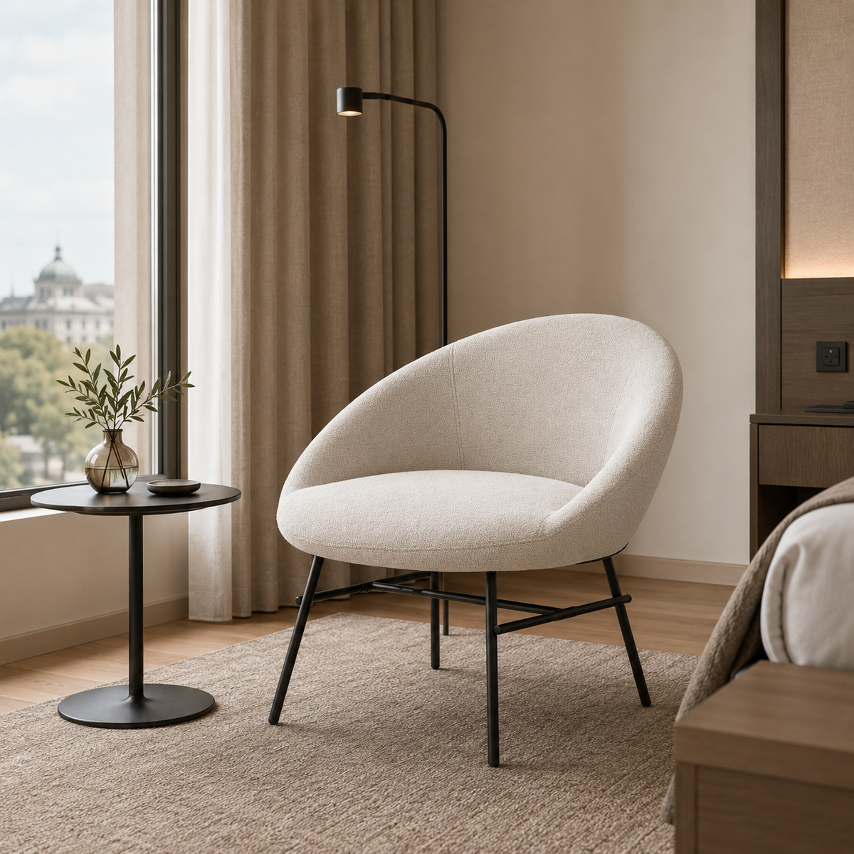 Curved-back Bouclé lounge armchair in Chalk beside window in hotel guestroom reading corner RC-09