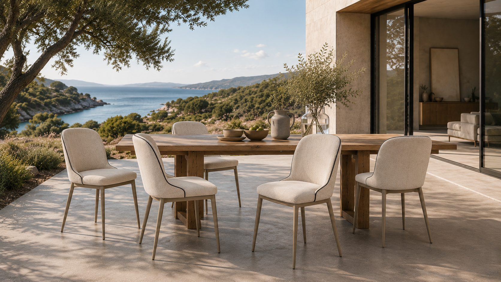 Soft profile dining chairs around an outdoor dining table in a modern villa terrace setting