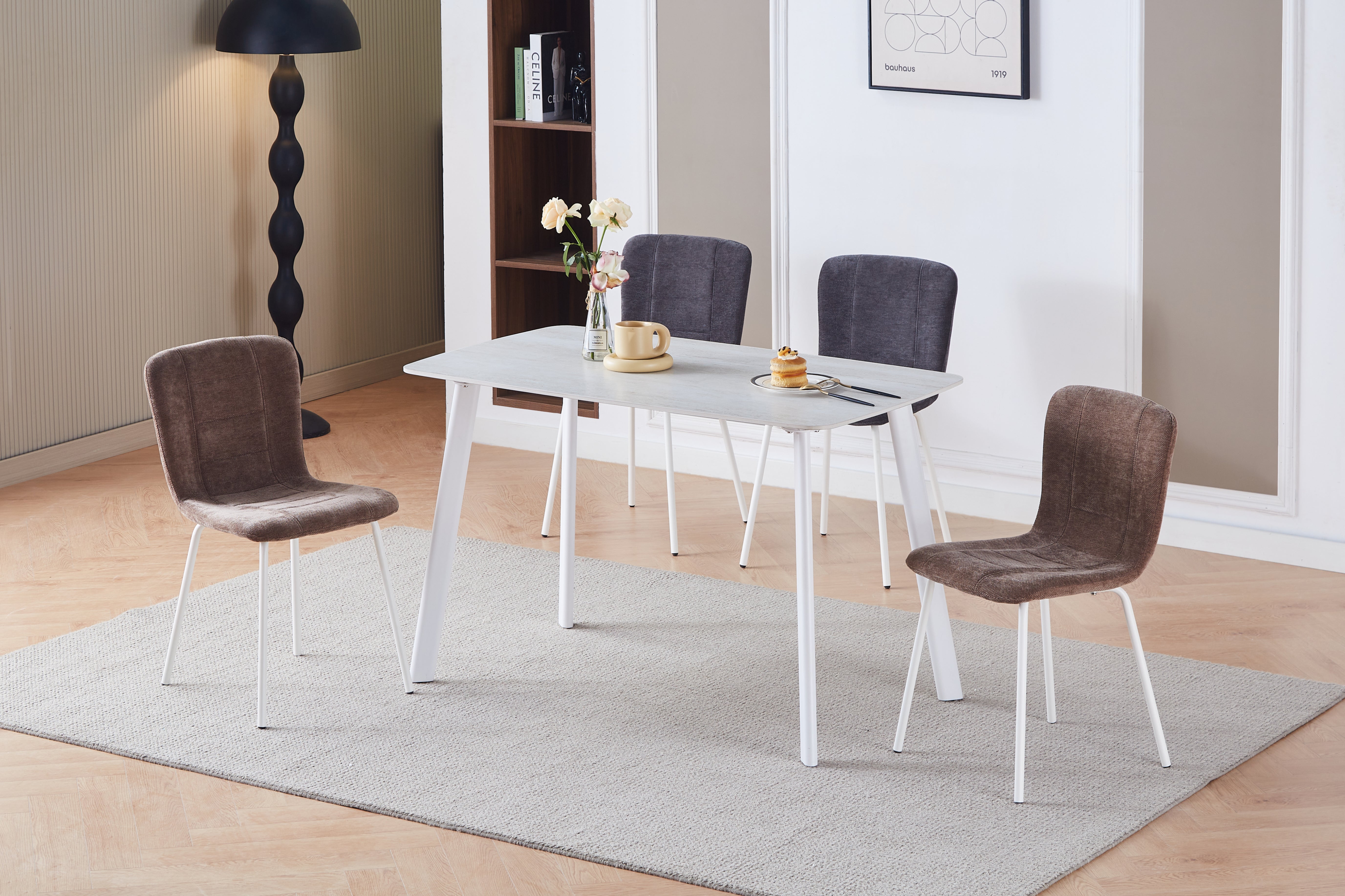 T-138 Sintered Stone Dining Table in Residential Dining Room — Travertine White Top, Sand-White Splayed Steel Legs, Styled with Upholstered Dining Chairs — GEYA Seating
