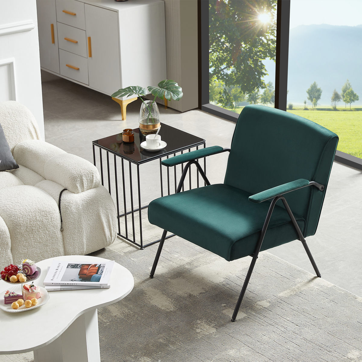 Forest green velvet lounge armchair in an open-plan living room beside a bouclé sofa and floor-to-ceiling window RC-03