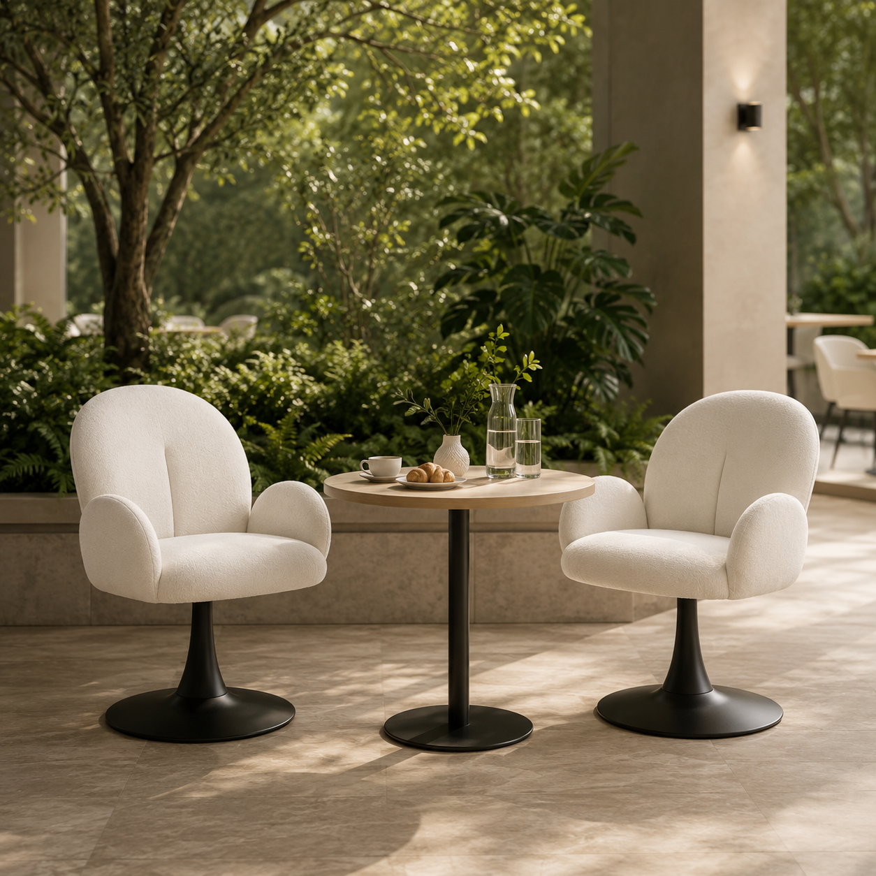 White upholstered pedestal swivel lounge chairs with black round bases in a green boutique hotel breakfast lounge with a small round table and natural daylight.