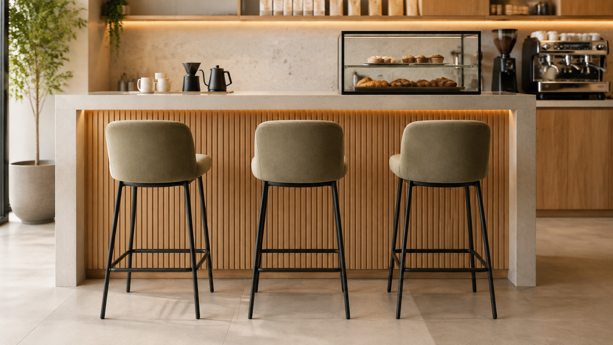 Upholstered 24-inch counter-height stools with slim metal frames at a standard café counter-height surface.