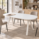 All-white barrel-top dining table in a sunlit architectural studio with upholstered dining chairs, T-309
