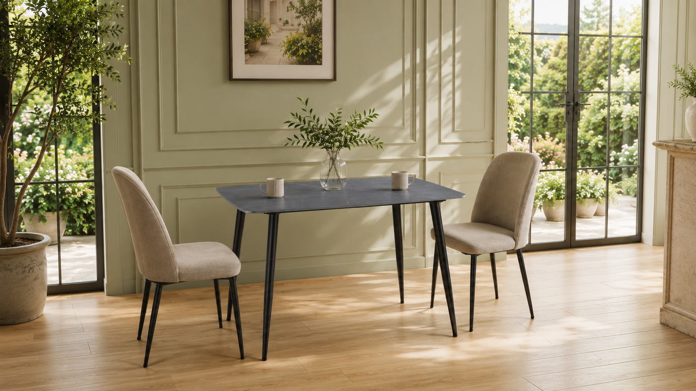 GEYA T-107 rectangular sintered stone dining table in Armani Grey with matte black splayed legs, styled in a bright residential dining room setting.