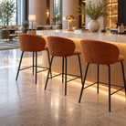 Bouclé bar stools in rust brown arranged along a bar counter, showing repeated rounded wraparound backs and black four-leg frames, BC-107-750
