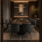 Charcoal grey faux leather dining chairs arranged around oval dark wood table in private dining room with warm panel lighting — DC-3063

