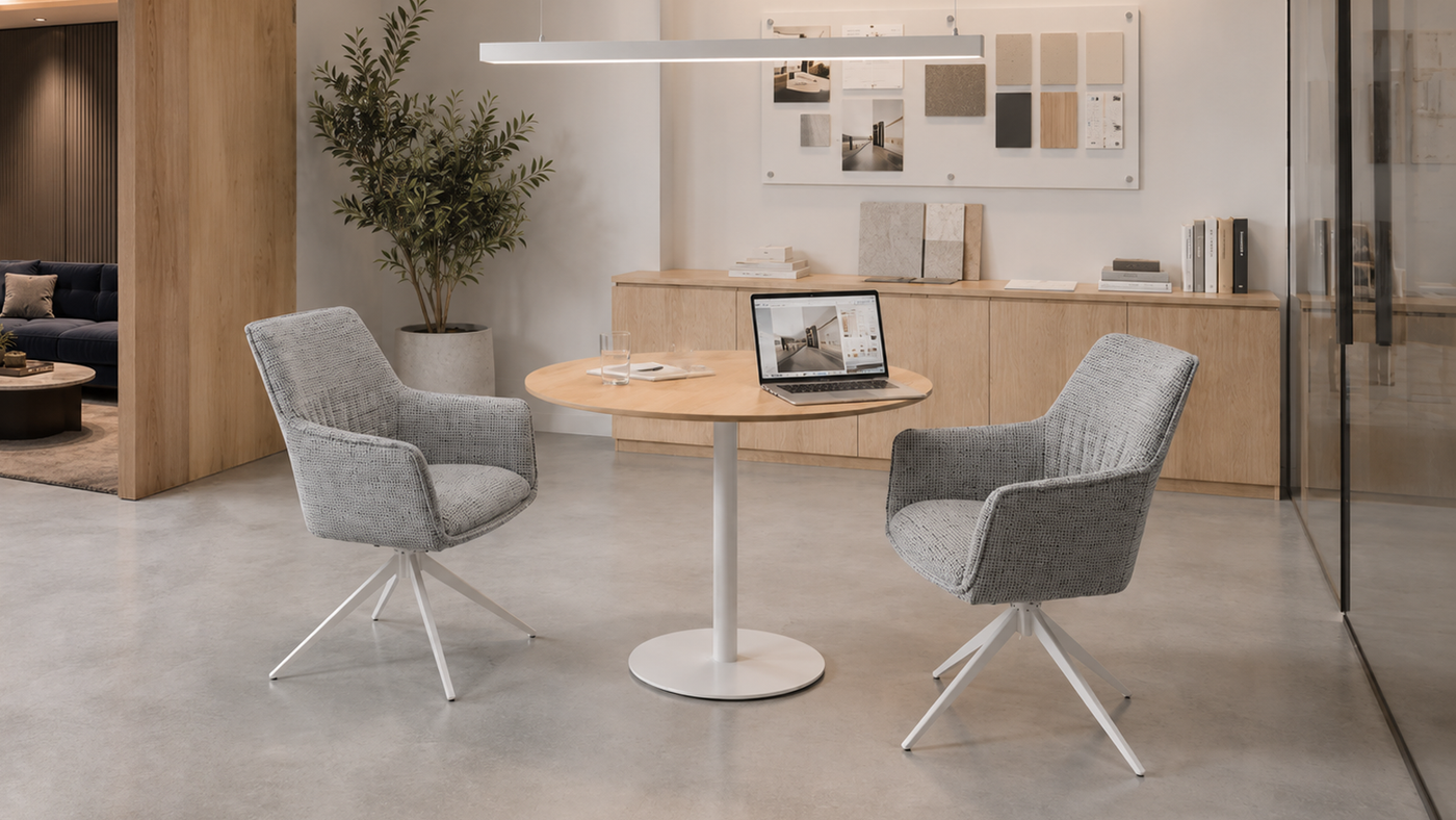 DC-5050 swivel armchairs in an office client discussion area with a round table, laptop, material board, and glass partition