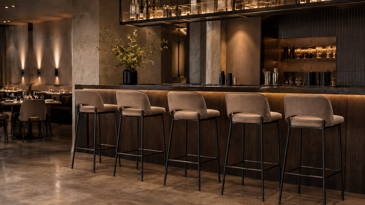 Upholstered bar stools with metal frames in a refined restaurant bar setting.