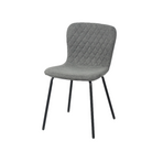 Linen look diamond-quilted dining chair in charcoal at restaurant table, GEYA Seating DC-1060-C