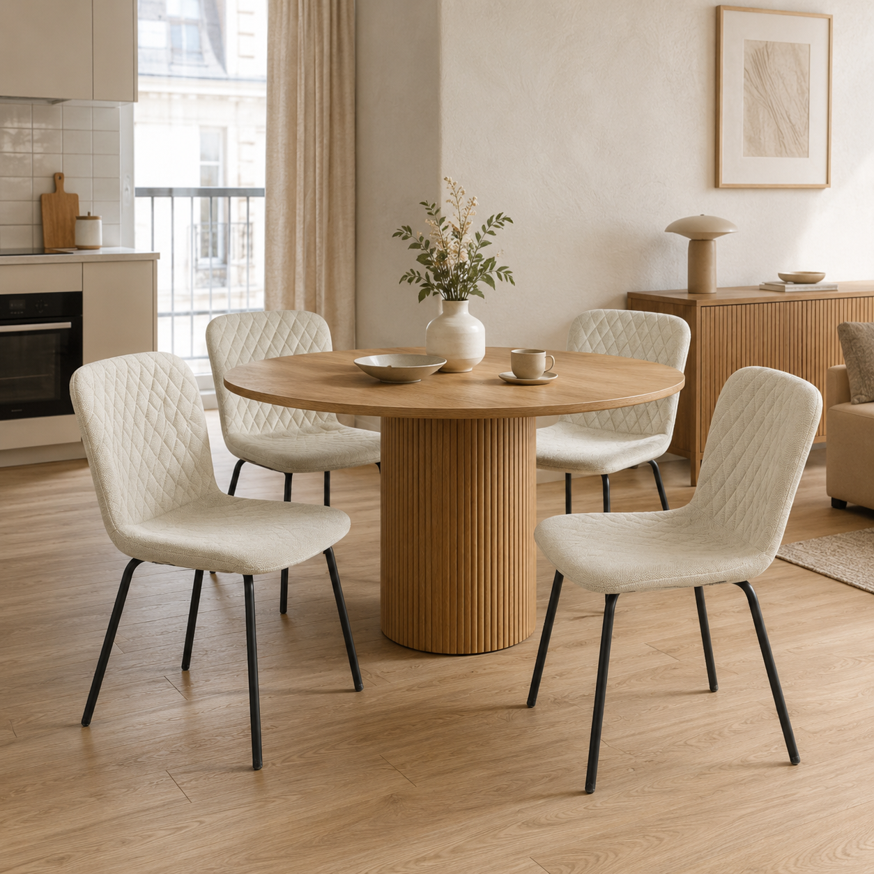 Linen look diamond-quilted dining chairs in cream around round pedestal table in open-plan apartment — DC-1060-C