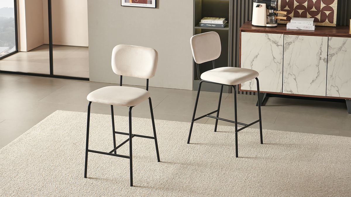 Velvet bar stools in ivory shown as a pair beside a cabinet, with separate upholstered backs and black steel frames, BC-182-750