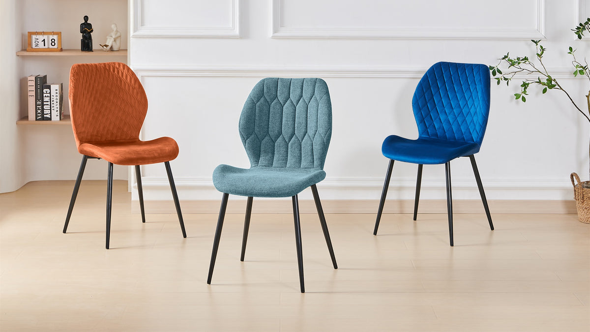 Geometric-stitched dining chair in teal with orange and blue companion chairs against a panelled wall, DC-3071