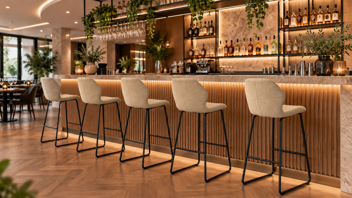 Bar stools in Linen arranged along an illuminated commercial bar counter in a linear layout BC-05-750
