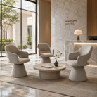 Mélange woven pedestal swivel lounge armchairs in boutique hotel lobby reception seating area with marble wall, round coffee table and natural light — GEYA Seating DC-5077.
