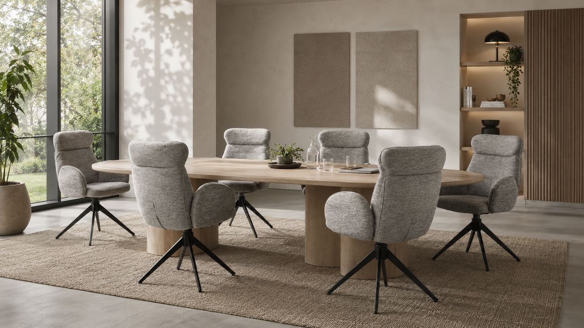 Six mélange woven wingback swivel conference armchairs around an oval oak table in a light office meeting room with floor-to-ceiling windows and warm neutral interior.
