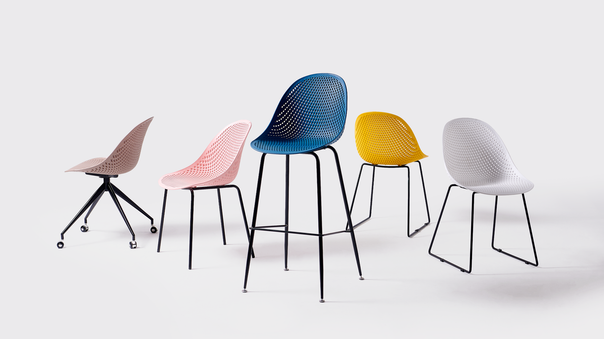 Perforated polypropylene seating collection in five shell colours including deep blue bar stool, blush pink and mustard yellow dining chairs, PC-76 series