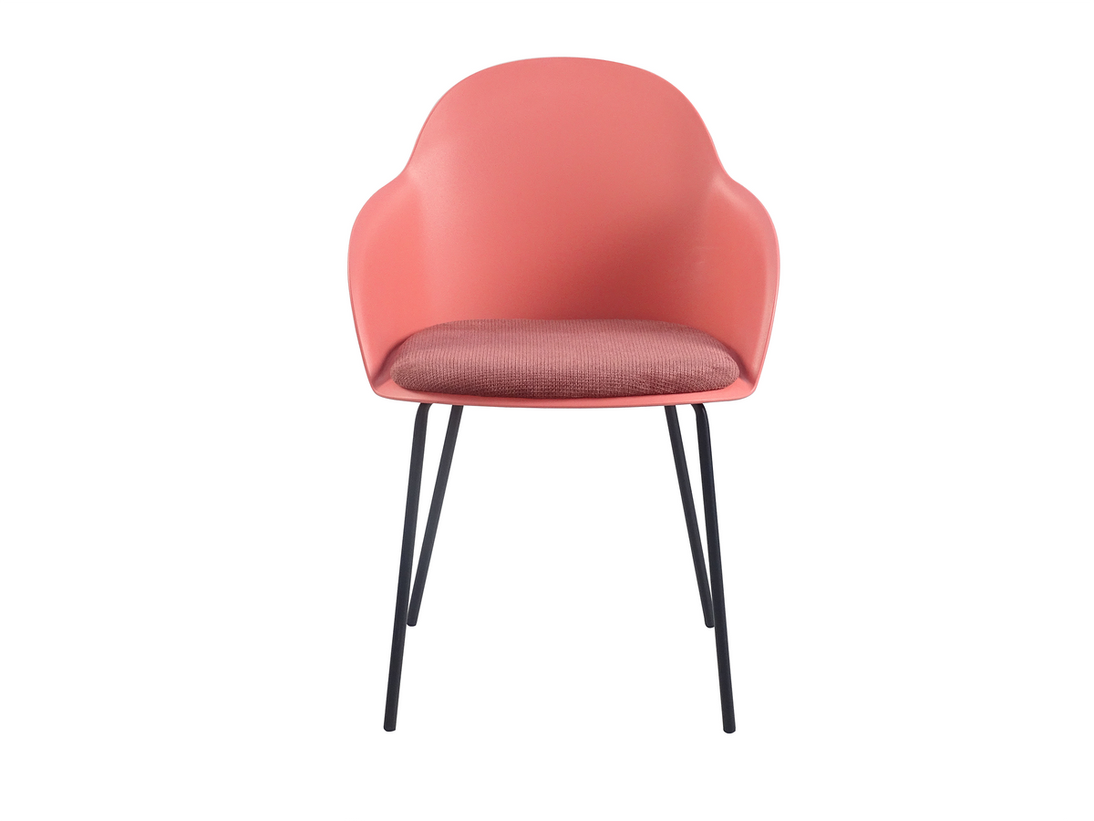 Front view of coral shell-back PP dining armchair showing integrated low armrests and tonal woven seat pad, GEYA Seating PC-16