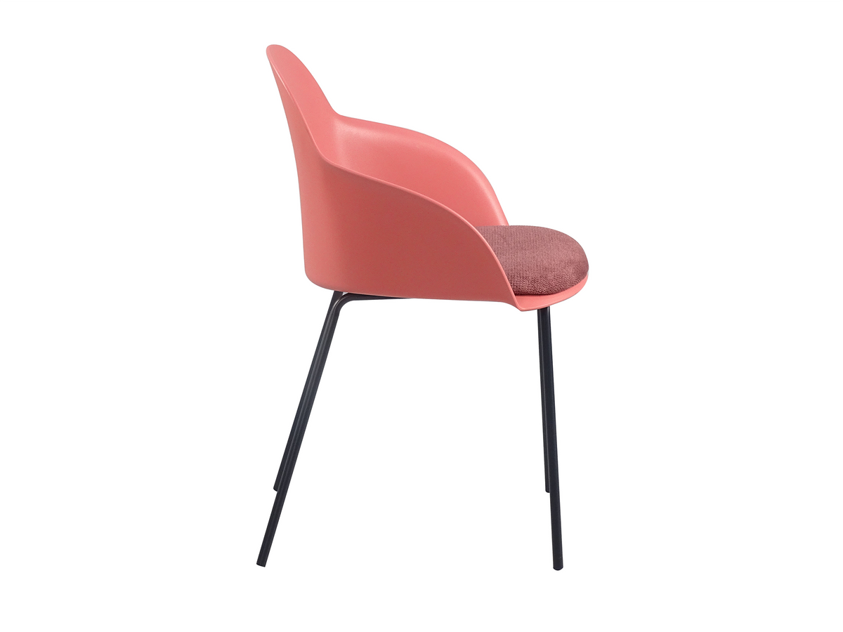 Side profile of coral PP shell-back armchair showing contoured backrest slope, seat depth and slender steel leg stance PC-16