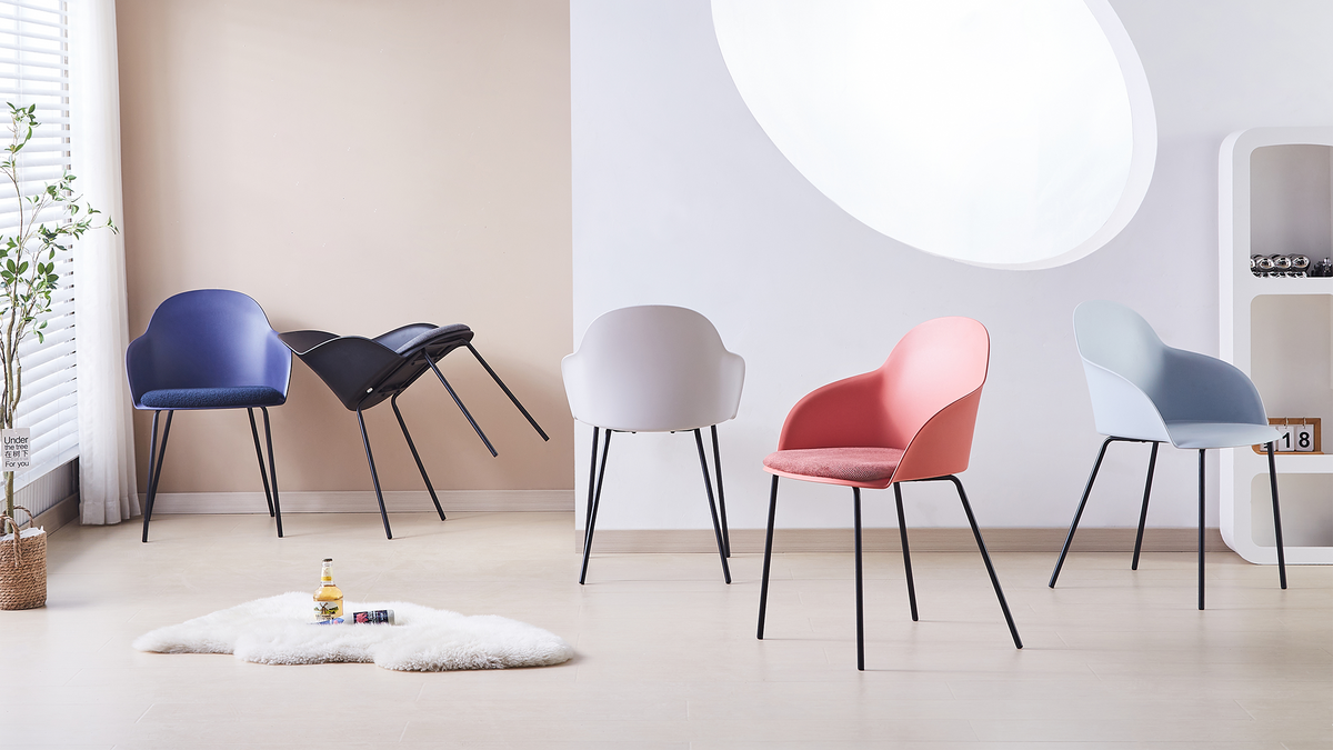Shell-back polypropylene dining armchairs in five shell colours arranged in open-plan residential dining space with natural light PC-16