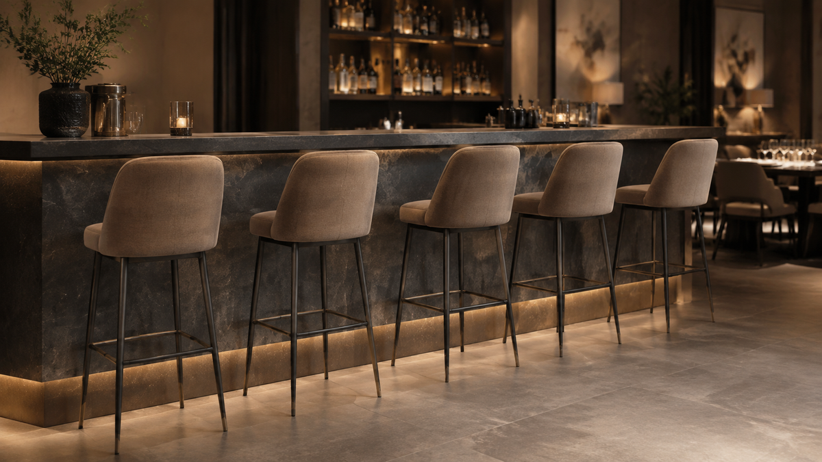 Commercial bar stools with upholstered backs and slim metal frames at a refined restaurant bar and dining setting.