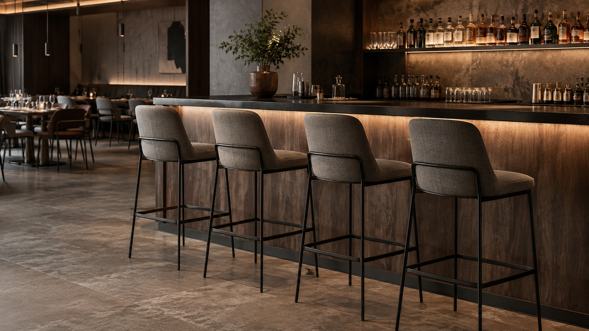 Commercial upholstered bar stools with metal frames in a contemporary restaurant bar setting.