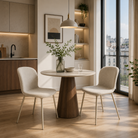 Shell back upholstered side chair in ivory fabric for compact apartment dining space with round pedestal table — DC-1062