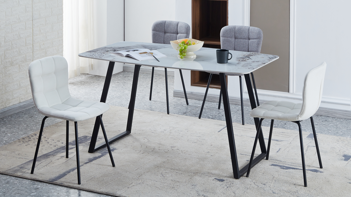 Sintered stone dining table with four quilted chairs, pale wall panelling and a textured rug, T-122