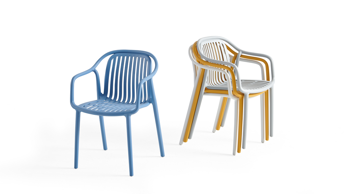 Stackable slatted polypropylene armchairs showing compact vertical stacking for high-density commercial dining, PC-112