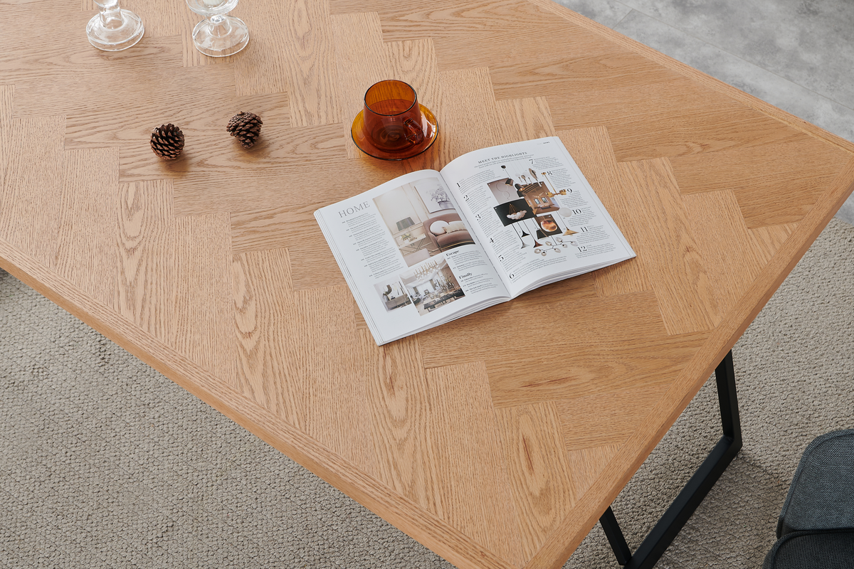 Herringbone oak veneer dining tabletop showing square edges and natural wood grain in close-up, T-103