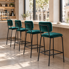 Velvet bar stools in deep teal arranged along a café window counter, showing their tubular steel back frames, BC-182-750