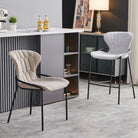 Winged-back upholstered bar stools with wraparound steel frames arranged at a ribbed island counter, BC-85-750