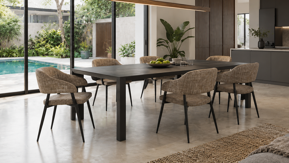 Wraparound open-back dining armchairs in walnut brown mélange woven fabric at a dark rectangular dining table, open-plan interior with garden view, DC-1536