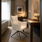 Wraparound high-back swivel armchair in decorative bouclé at boutique hotel guestroom desk, warm ambient lighting with dark timber furniture, suitable for FF&E seating specification, DC-5051